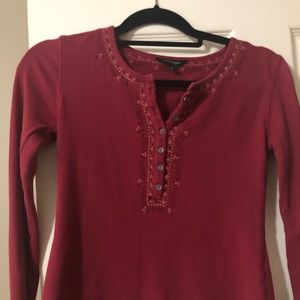 Red long sleeve top.